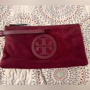 Tory Burch suede and leather clutch with wristlet strap.